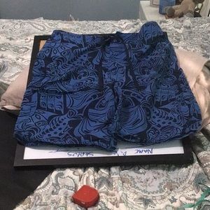 Medium blue on navy blue background on swim shorts with right side Pocket &